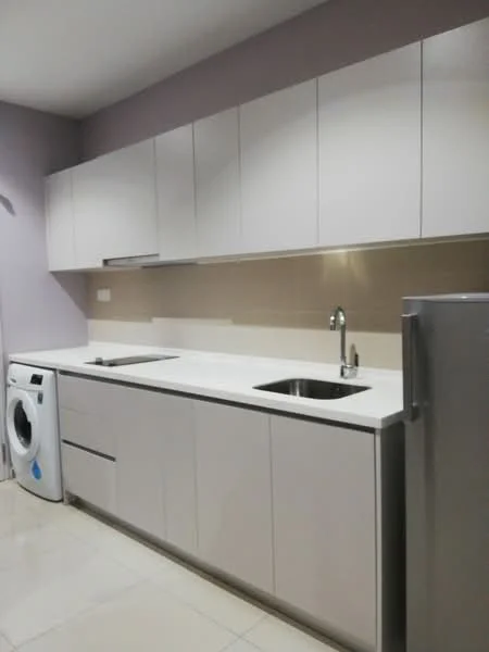 Kitchen features: white cabinetry, white countertop, single-bowl stainless-steel sink, chrome pull-down faucet, built-in oven, fridge, front-load washing machine, ceramic tile flooring, light grey painted walls, recessed downlights; style: modern.