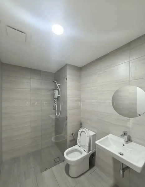 Bathroom features: walk-in shower with glass enclosure, chrome handheld shower, white toilet, white wall-mounted sink, round mirror, light grey tile cladding on walls, light grey tile flooring, recessed ceiling lights; style: modern.