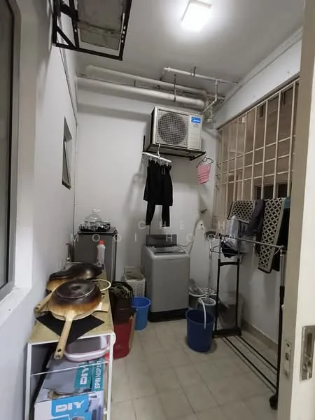 Laundry features: wall-mounted split AC, top-load washing machine, tumble dryer, metal shelving unit, plastic laundry basket, hanging clothes rack, ceramic tile flooring, white painted walls, window with security bars, sinks with metal pots.