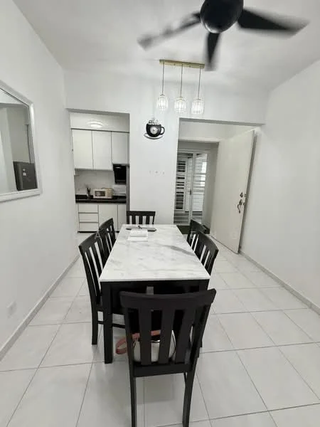 Dining features: marble dining table, black wooden dining chairs, white painted walls, white tiled flooring, 5-blade ceiling fan with light, pendant lighting above table, mirror on wall, open doorway to kitchen, sliding door to outside, decorative wall clock; style: modern. Kitchen features: white cabinetry, black countertop, microwave, kitchen appliances visible, open layout to dining area; style: modern.