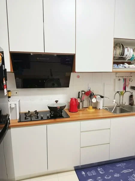 Kitchen features: white cabinetry, wood countertop, black glass cooktop, stainless-steel sink, chrome pull-down faucet, black range hood, red kettle, white toaster, open shelving with dishes, wall-mounted utensils holder, blue area rug; style: modern.