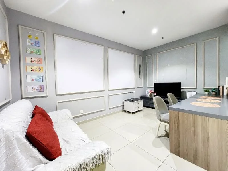 Living features: white fabric sofa with red cushions, grey painted walls, decorative wall panels, flat-screen TV on a low console, light-colored wooden console table, two grey dining chairs, tile flooring, recessed ceiling lights, decorative artwork on walls; style: modern.