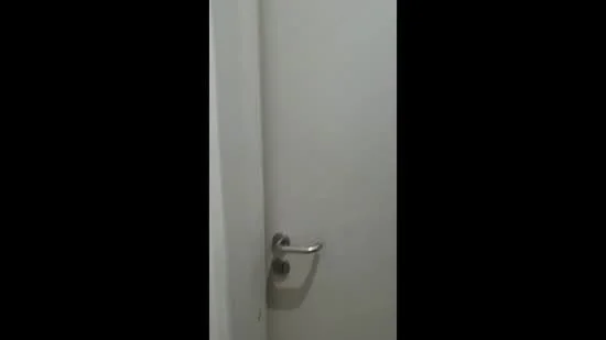Room features: white painted walls, plain door, metal door handle.
