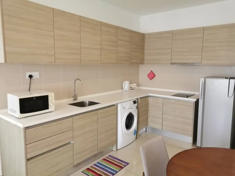 Kitchen features: light wood cabinetry, white countertop, single-bowl stainless-steel sink, chrome pull-down faucet, built-in washing machine, microwave, stainless-steel fridge, ceramic tile flooring, wall-mounted electrical outlet, colorful area rug, dining table, wall cabinets; style: modern.
