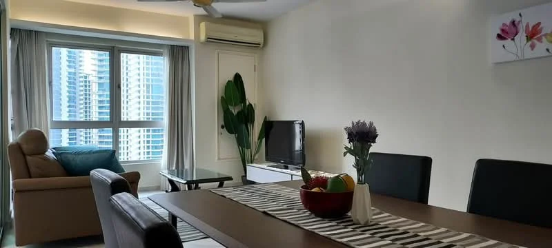 Dining features: dining table with 6 chairs, vase with flowers on table, fruit bowl on table, striped table runner, wall-mounted TV, light-colored walls, large window with city view, curtains, ceiling fan, sofa in background, green plant in corner, coffee table; style: modern; view: city.