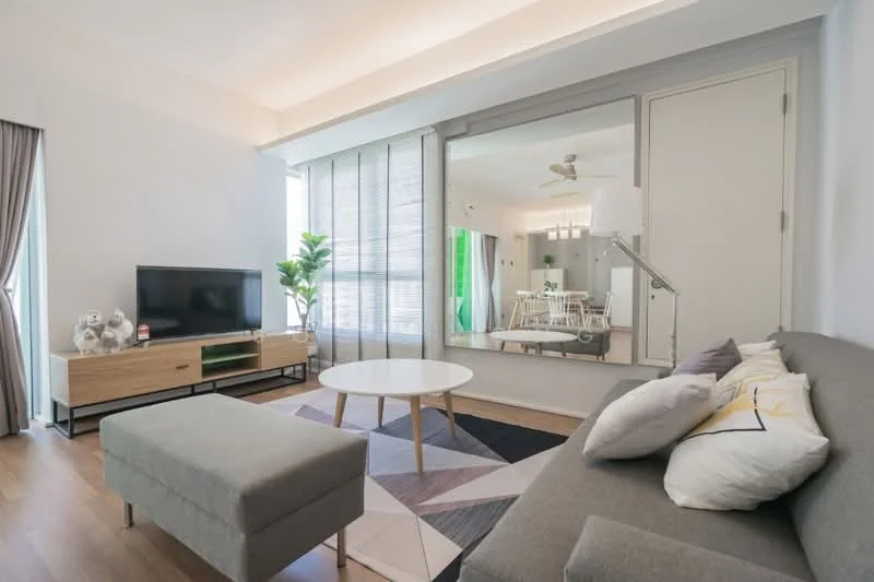 Living features: grey fabric sofa, round coffee table, TV console in light wood, wall-mounted TV, decorative pillows, area rug with geometric pattern, floor-to-ceiling windows, curtains, plant in ceramic pot, mirrored wall, wooden flooring, ceiling fan with light; style: modern.