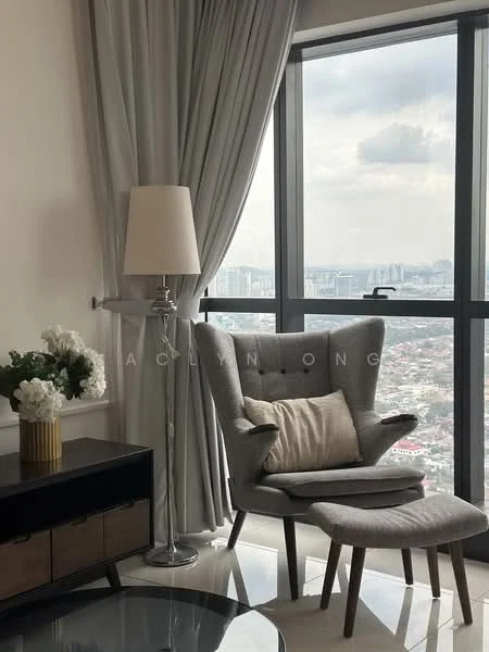 Living features: grey upholstered armchair, matching footrest, floor lamp with white shade, black console table with gold accents, decorative white flowers in a vase, large window with city view, sheer grey curtains, polished tile flooring; style: modern; view: city.