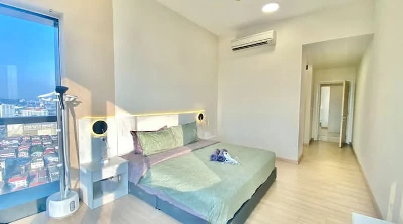 Bedroom features: king-size bed with green bedding, upholstered headboard, 2 bedside lamps, floor-to-ceiling window with city view, light wood flooring, wall-mounted split AC, recessed downlights, decorative wall paneling, sliding door leading to hallway; style: modern; view: city.