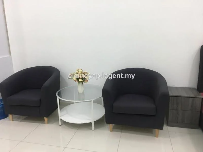 Room features: two black upholstered armchairs, round white coffee table, small side table with wood finish, decorative flower arrangement, glossy white tiled flooring, plain white walls, neutral lighting; style: modern.
