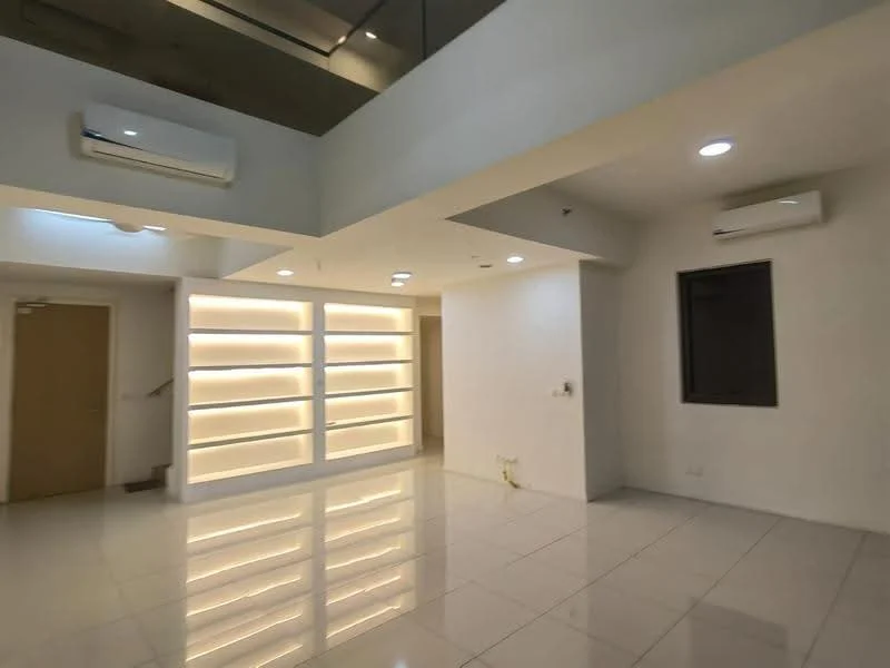 Room features: white painted walls, glossy tile flooring, recessed downlights, 2 wall-mounted split AC units, built-in shelving with backlighting, single window, open layout, high ceiling; style: modern.