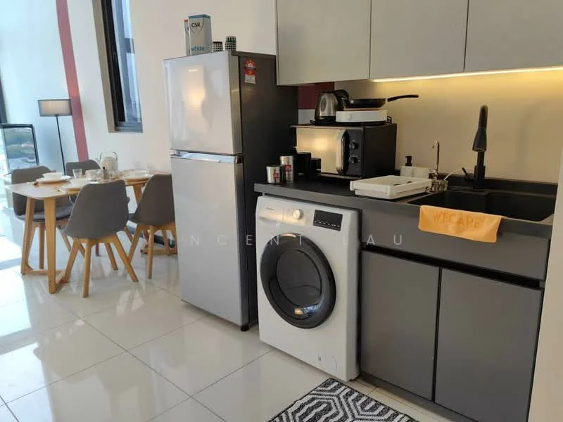 Kitchen features: grey cabinetry, black countertop, single-bowl stainless-steel sink, chrome pull-down faucet, built-in microwave, stainless-steel fridge, front-load washing machine, coffee machine, kitchen utensils, dining table with 4 chairs, area rug with geometric pattern, white tiled flooring, recessed LED downlights; style: modern.