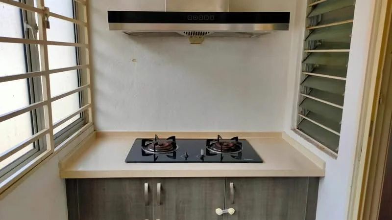 Kitchen features: grey cabinetry, light-colored countertop, built-in gas hob with 2 burners, stainless-steel range hood, window with horizontal slats, white painted walls; style: modern.