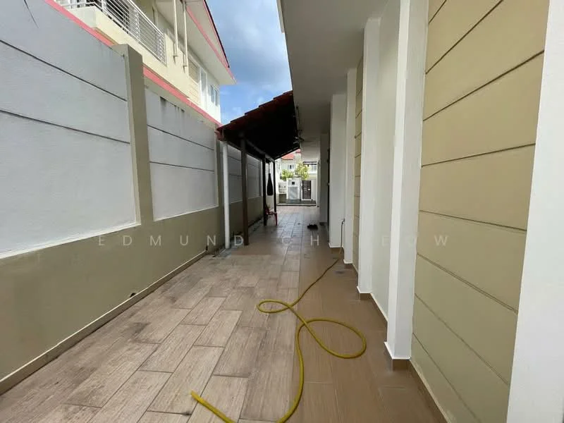 Exterior features: side walkway, grey painted walls, wooden paneling, tiled flooring, overhead roof, drainage hose, adjacent building, partially cloudy sky; style: modern.