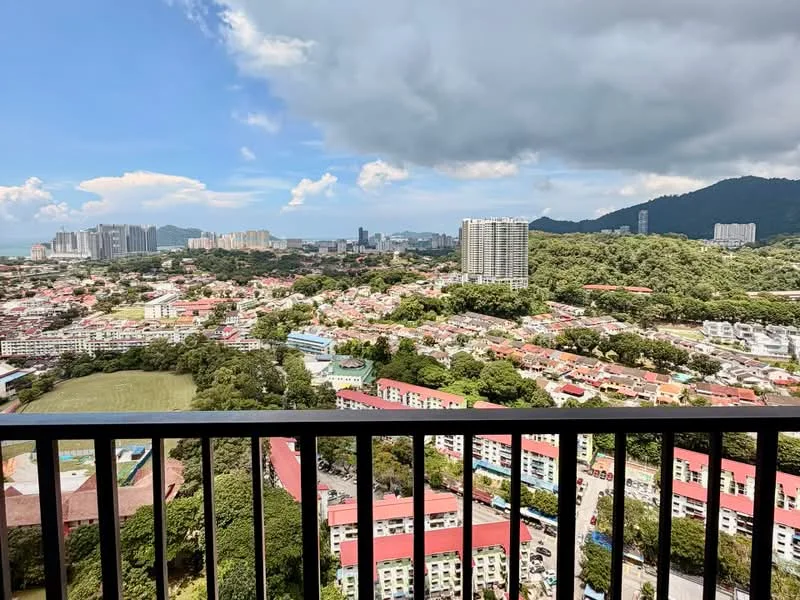 Exterior type: high-rise condominium; features: city skyline view, surrounded by greenery, nearby residential areas, mountain view in background, balcony railing, clear blue sky, cloudy weather, urban landscape; style: modern.