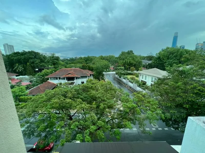 Exterior features: lush greenery, mature trees, residential houses, paved road, city skyline in background, cloudy sky.