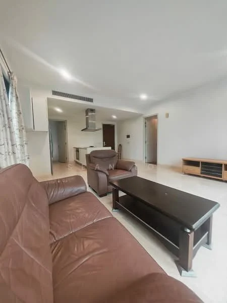 Living features: brown leather sofa, 2-seater armchair, coffee table, TV console, recessed ceiling lights, cream painted walls, tile flooring, floor-to-ceiling windows with sheer curtains, open layout to kitchen, kitchen island visible; style: modern.