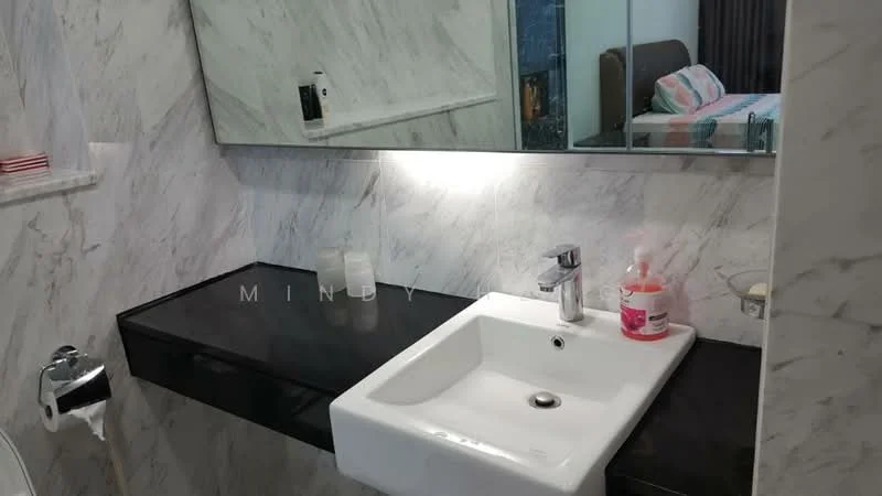 Bathroom features: white ceramic sink, chrome basin mixer faucet, black countertop, marble wall cladding, wall-mounted mirror, toilet roll holder, soap dispenser, light fixture above sink; style: modern.