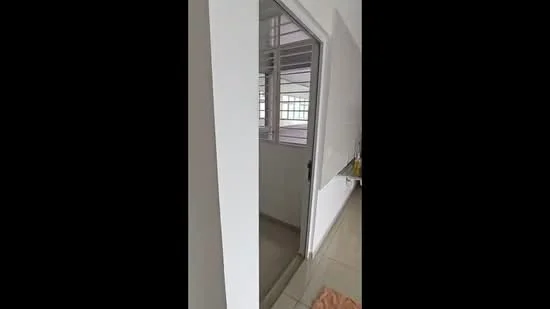 Room features: white painted walls, tile flooring, sliding glass door, window with metal grille, neutral color scheme, corner view, door frame, visible floor transition.