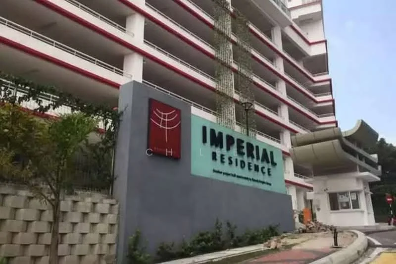 Exterior type: low-rise apartment block; features: white painted facade, red accent details, balconies with railings, landscaped garden area, signage with 'IMPERIAL RESIDENCE', paved walkway, entrance canopy, surrounding greenery; style: modern.