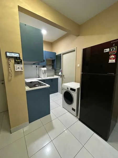 Kitchen features: blue cabinetry, white countertop, stainless-steel sink, built-in stove, black refrigerator, white washing machine, ceramic tile flooring, cream painted walls, overhead cabinets, microwave on countertop; style: modern.