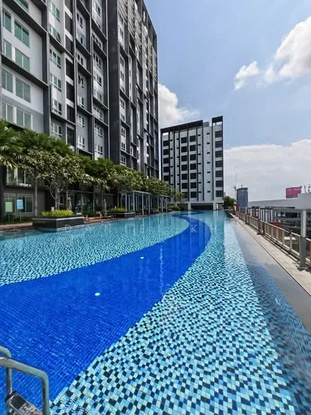Exterior type: high-rise condominium; features: infinity pool, swimming pool deck, tiled pool surface with blue and white mosaic pattern, landscaped greenery along the poolside, surrounding high-rise buildings, sunny sky, railings along the pool deck; style: modern.