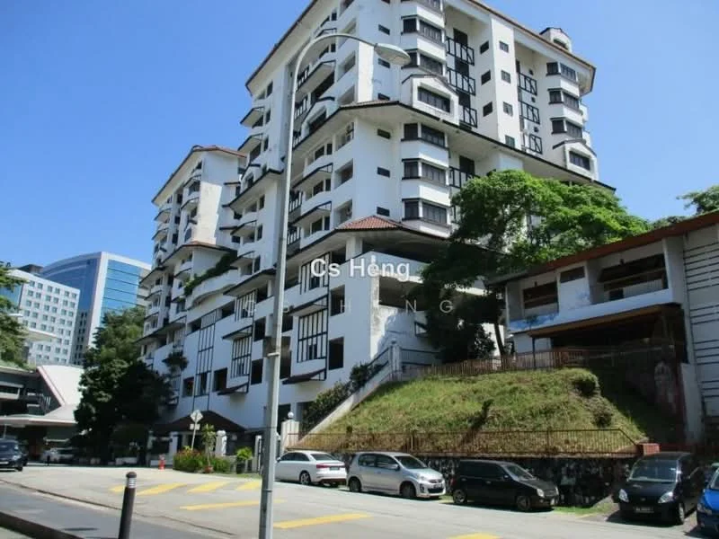 Exterior type: low-rise apartment block; features: white painted facade, black window frames, red tiled roof, multiple balconies, landscaped garden area, surrounded by greenery, parking spaces visible, 3-storey building, adjacent to road; style: modern.