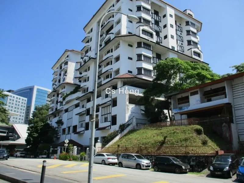 Exterior type: low-rise apartment block; features: white painted facade, black window frames, red pitched tile roof, multiple balconies, landscaped garden area, surrounded by greenery, parking spaces visible, 3-storey building, urban context with nearby buildings; style: modern.