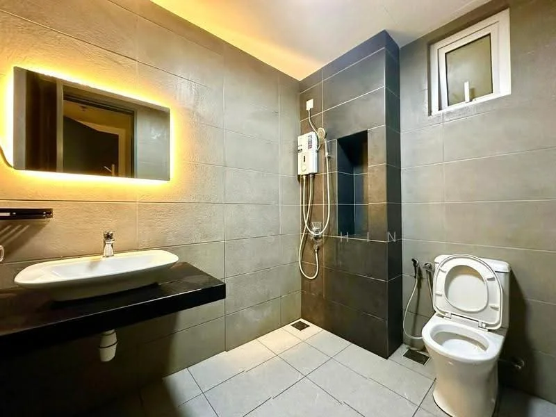 Bathroom features: single-sink vanity with black countertop, framed mirror with LED backlighting, wall-mounted shower with handheld showerhead, toilet with dual flush, grey tile walls, light grey tile flooring, window for natural light, built-in niche for toiletries; style: modern.