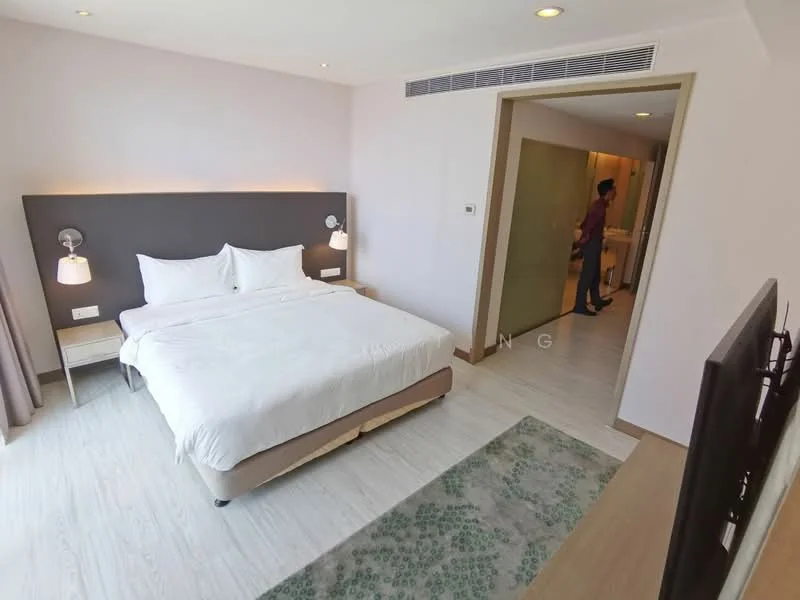 Bedroom features: king-size bed with white bedding, upholstered headboard in grey, two wall-mounted bedside lamps, wooden flooring, large window with sheer curtains, TV on a wooden console, decorative area rug with geometric pattern, built-in wardrobe, neutral painted walls, recessed ceiling lights; style: modern. Room features: doorway leading to bathroom, light-colored walls, wooden door.