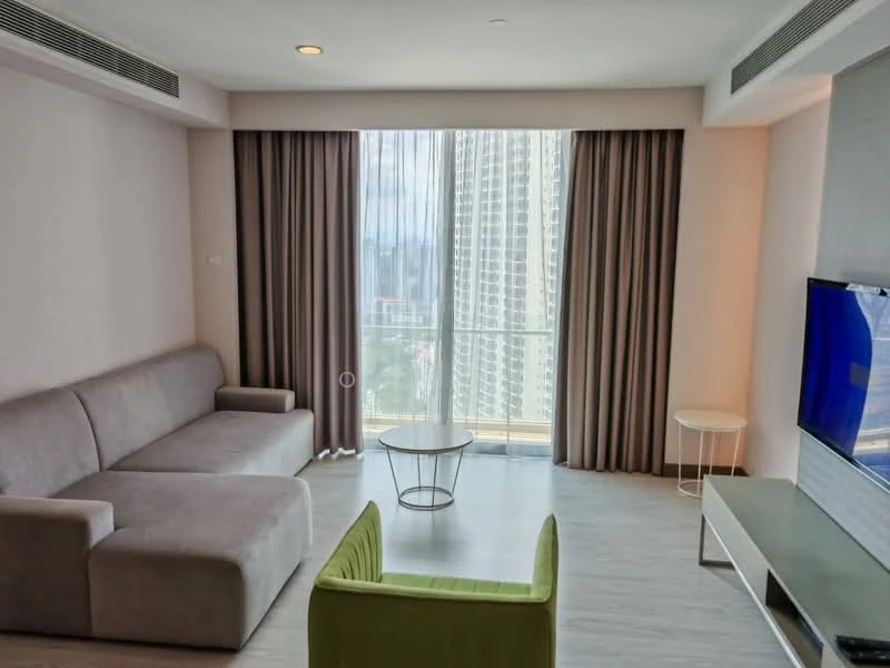 Living features: grey fabric sofa, green accent chair, glass coffee table, TV console, wall-mounted TV, floor-to-ceiling windows, sheer curtains, light wood flooring, recessed downlights, neutral painted walls; style: modern; view: city.