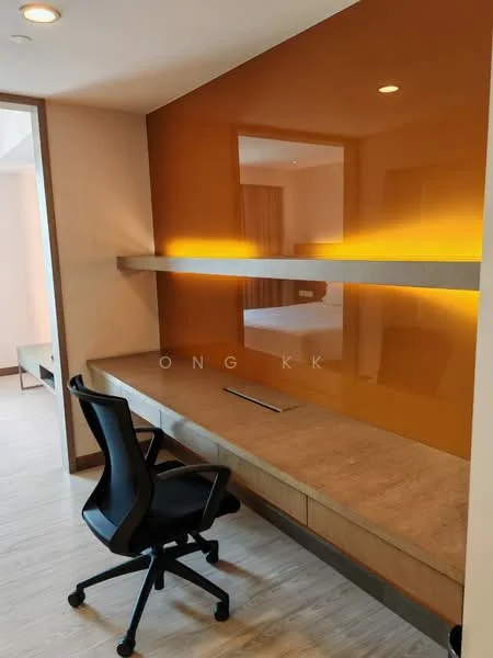Study features: orange accent wall, built-in desk with concrete top, black office chair, wood cabinetry below desk, recessed LED lighting, light wood flooring, neutral wall color, open space view; style: modern.