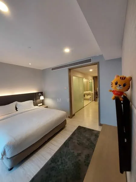 Bedroom features: king-size bed with white bedding, upholstered headboard, nightstand with lamp, wall-mounted TV, wooden flooring, decorative wall art, large window with sheer curtains, plush area rug, built-in wardrobe, decorative figurine on shelf; style: modern. Bathroom features: glass shower enclosure, single-sink vanity with mirror, toilet, tile flooring, frosted glass door.