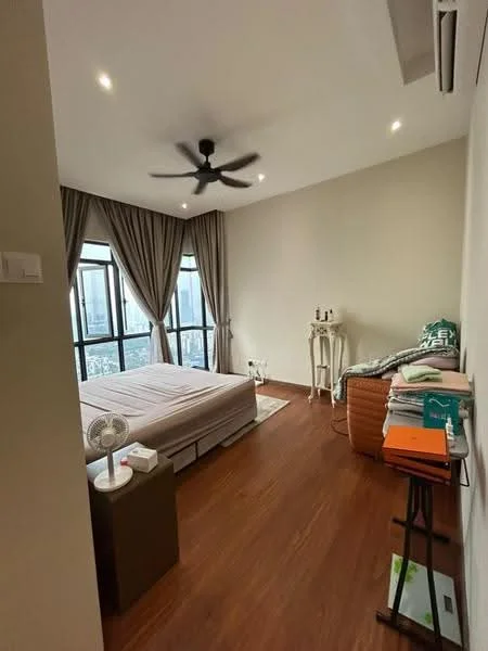 Bedroom features: wooden flooring, light grey painted walls, 5-blade ceiling fan with light, floor-to-ceiling windows, sheer curtains, queen-size bed, upholstered headboard, side table, decorative chair, stack of books, small fan, decorative plant, wall-mounted air conditioning unit; style: modern; view: city.