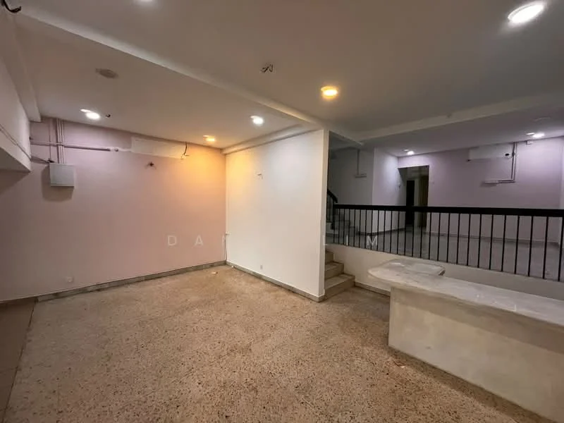 Room features: exposed concrete flooring, white painted walls, soft purple accent wall, recessed downlights, staircase leading to upper level, wall-mounted electrical panel, open layout, no visible furniture; style: modern.