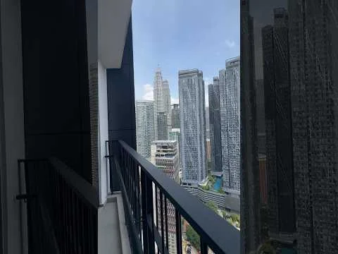 Room features: balcony, metal railing, city skyline view, high-rise buildings in view, glass sliding door, concrete flooring, partially covered ceiling; style: modern; view: city.