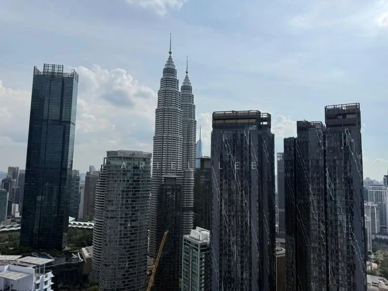 Exterior type: high-rise condominium; features: glass curtain wall, tall skyscrapers, city skyline, surrounded by urban landscape, Petronas Twin Towers visible, mixed-use development, modern architectural design; style: modern.