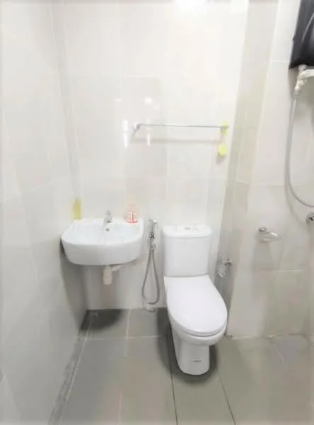 Bathroom features: white ceramic toilet, wall-mounted sink, chrome basin mixer faucet, handheld shower, tile flooring, white tiled walls, towel rack, shower hose, drainage outlet; style: modern.