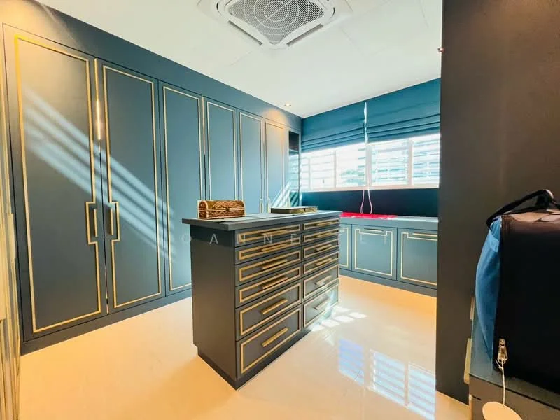Laundry features: blue cabinetry with gold handles, large storage cabinets, central island with drawers, white countertop, window with horizontal blinds, recessed ceiling lights, air conditioning unit, polished tile flooring; style: modern.