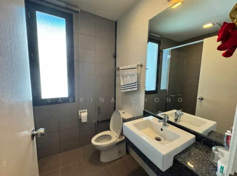 Bathroom features: grey tiled walls, white painted walls, dark granite countertop, single-sink vanity, chrome basin mixer faucet, framed mirror, one-piece toilet, window with frosted glass, towel rack, white hand towel, light fixtures, floor tiles in grey, toilet paper holder; style: modern.