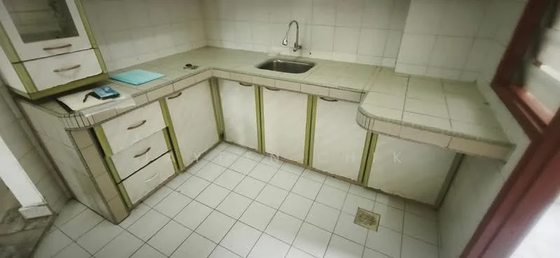 Kitchen features: single-bowl stainless-steel sink, chrome faucet, white tiled walls, light grey countertop, green trim on cabinetry, white cabinetry with green handles, ceramic tile flooring, built-in corner countertop, open shelving, floor drain.