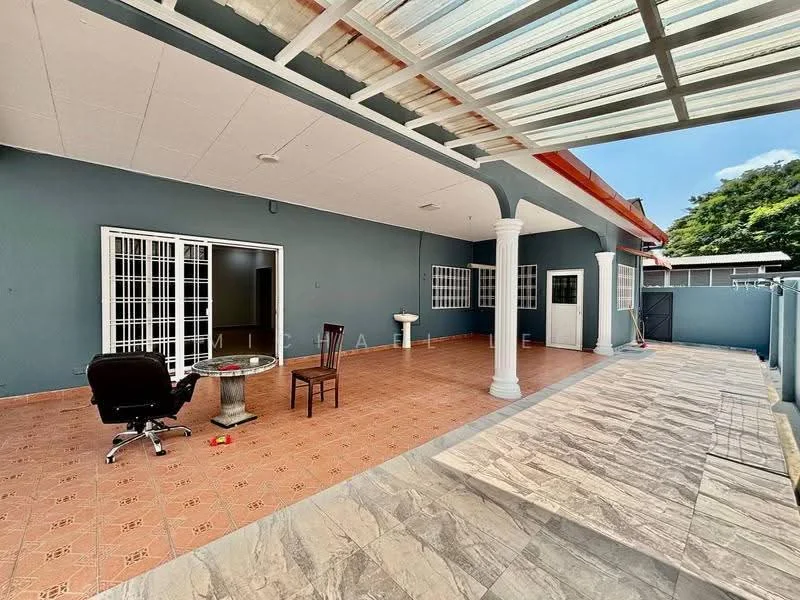 Exterior type: detached bungalow; features: covered porch area, terracotta tile flooring, white columns, sliding glass doors, large windows with white grilles, grey painted walls, outdoor seating area, manicured garden area, paved walkway, fenced perimeter; style: modern.