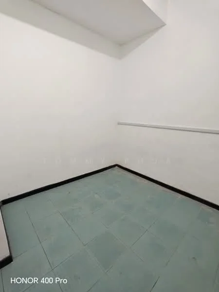 Room features: white painted walls, grey tiled flooring, corner room, no visible windows, minimal decor.