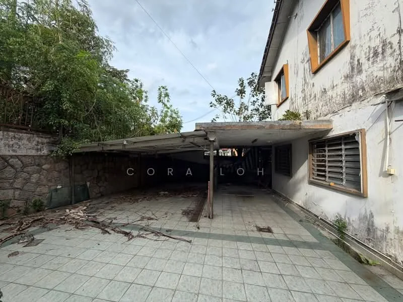 Exterior features: covered car porch, stone wall, tiled flooring, overgrown vegetation, exterior wall with peeling paint, windows with metal grilles, sloped roof, surrounding greenery; style: traditional.