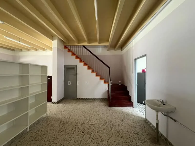 Room features: exposed beam ceiling, light yellow painted walls, terrazzo flooring, wooden staircase, metal door, sink with faucet, built-in shelving unit, staircase with wooden steps, window with natural light; style: modern.