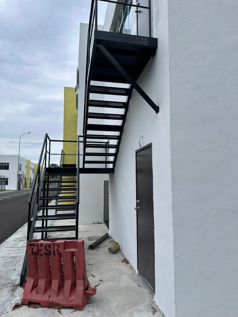 Exterior features: metal staircase, white painted facade, grey concrete wall, door with metal frame, concrete flooring, yellow accent wall, red construction barrier, urban street view; style: modern.