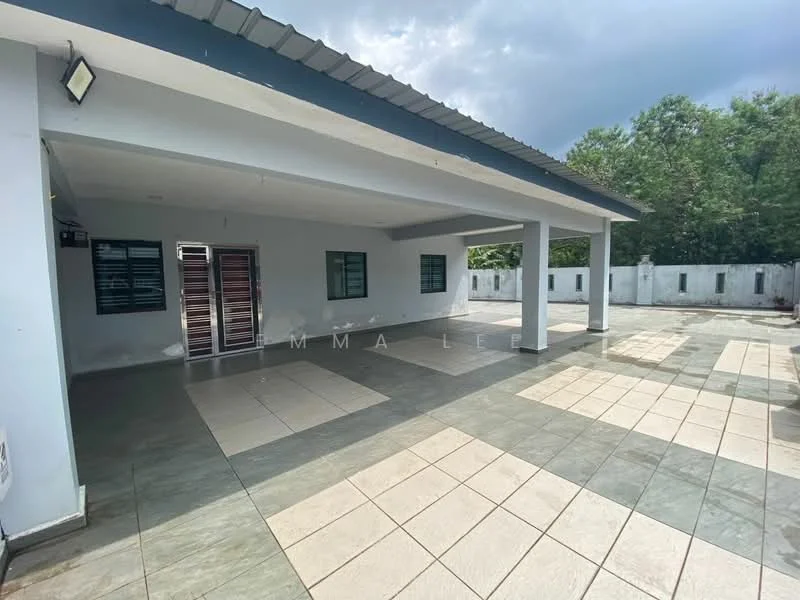 Exterior type: detached bungalow; features: flat roof, white painted facade, large outdoor patio area, grey tiled flooring, manicured landscaping, surrounded by greenery, multiple windows, outdoor lighting fixtures; style: modern.