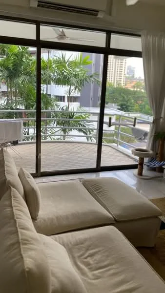 Living features: L-shape sectional sofa in cream fabric, floor-to-ceiling windows, sliding glass door, curtains, ceiling fan, decorative plants, area rug, coffee table; style: modern; view: city.