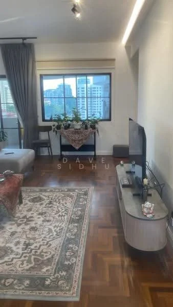 Living features: parquet wood flooring, large window with city view, grey fabric sofa, decorative area rug with intricate pattern, TV console, wall-mounted TV, indoor plants, decorative tablecloth, curtains, recessed lighting; style: modern; view: city.