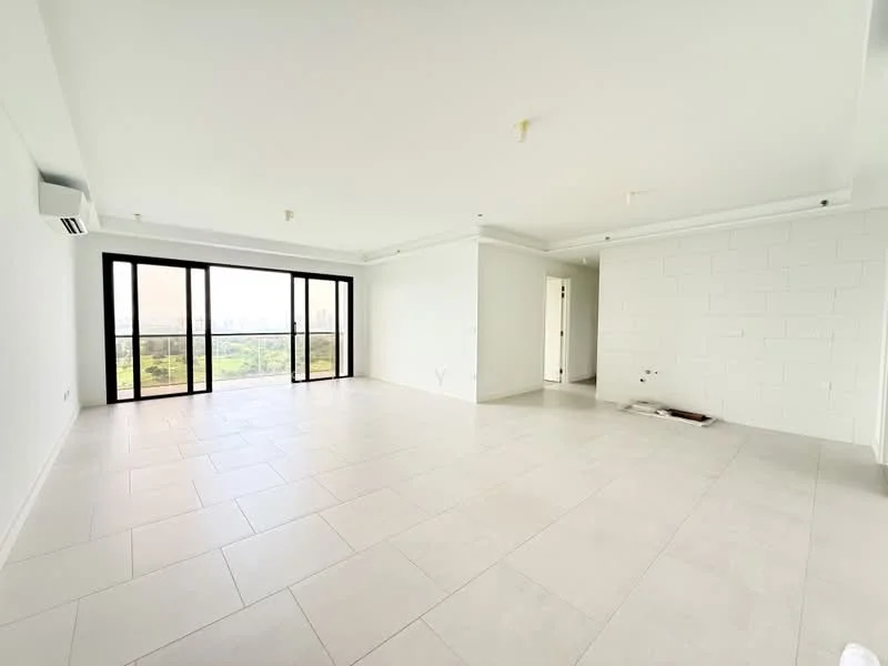 Living features: white painted walls, exposed brick accent wall, large floor-to-ceiling windows, sliding glass door, light-colored tile flooring, recessed downlights, 1 wall-mounted split AC, open layout, view of greenery, crown moulding, no visible furniture, neutral color scheme; style: modern; view: garden.