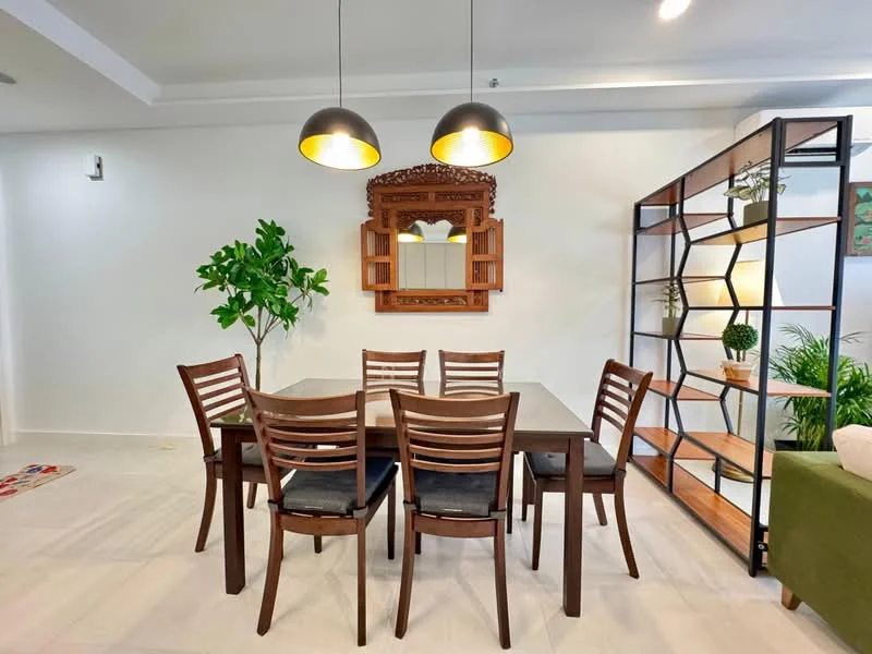 Dining features: 6-seater dining table, wooden dining chairs, black upholstered seat cushions, decorative wall mirror, green indoor plant, open shelving unit, wood and metal shelving, white painted walls, recessed ceiling lights, pendant lighting, light-colored flooring; style: modern.